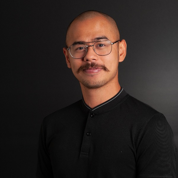 photo of Surya Sahetapy, a bald, mustached man in a black shirt
