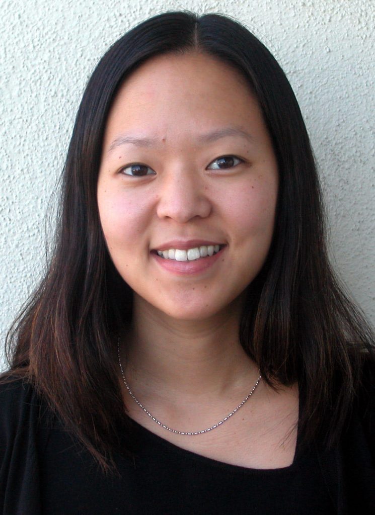 photo of Joann H. Lee, an Asian woman with straight black hair in a black top and thin silver necklace.